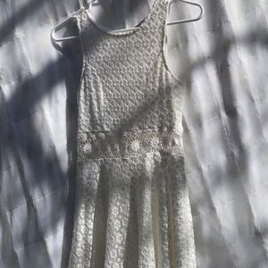 A white knee length dress with a flower cut out